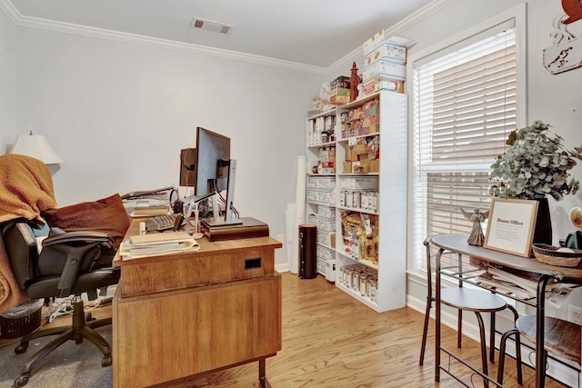 home office featuring visible vents, light wood-type flooring, and ornamental molding