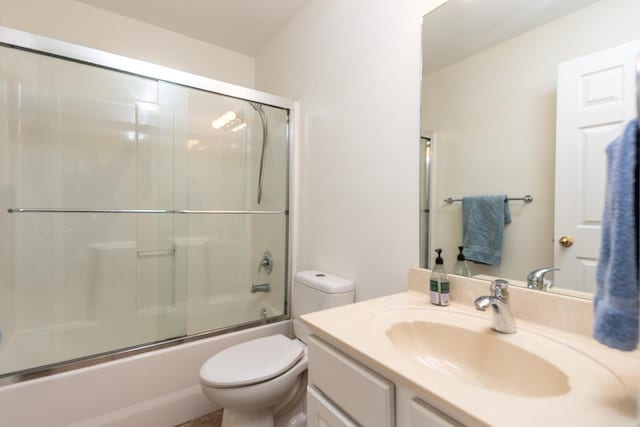 bathroom featuring shower / bath combination with glass door, vanity, and toilet