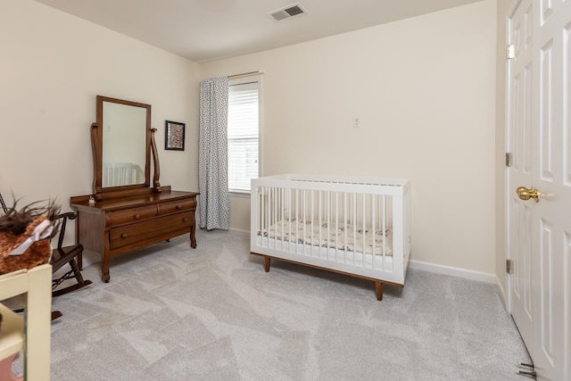 carpeted bedroom with visible vents and baseboards