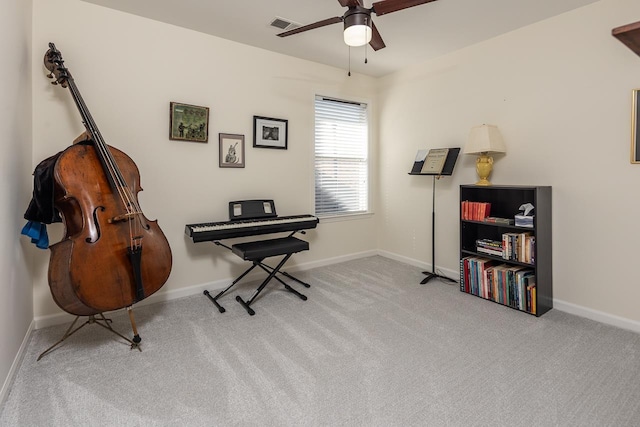 living area featuring carpet floors, visible vents, ceiling fan, and baseboards