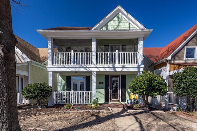 view of front facade with covered porch and a balcony