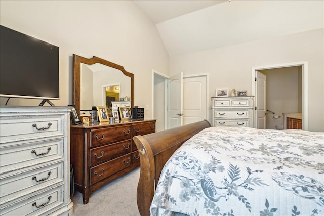 bedroom with lofted ceiling, a closet, and light carpet