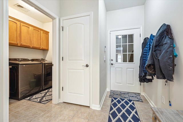 interior space featuring baseboards, visible vents, washing machine and clothes dryer, and light tile patterned floors