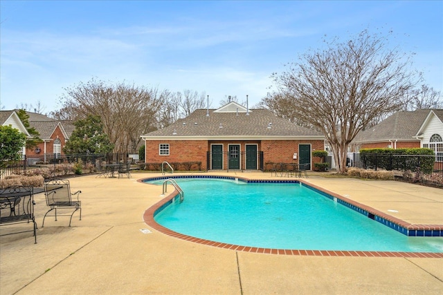 pool with fence and a patio