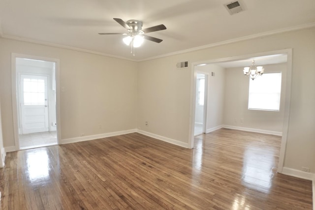 unfurnished room featuring crown molding, visible vents, wood finished floors, baseboards, and ceiling fan with notable chandelier