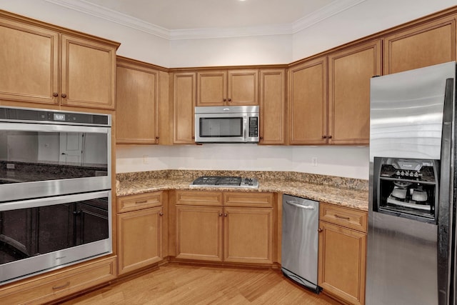 kitchen with light wood-type flooring, light stone countertops, stainless steel appliances, and crown molding