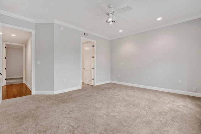 spare room featuring baseboards, visible vents, and crown molding