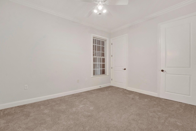 carpeted empty room featuring ceiling fan, ornamental molding, and baseboards