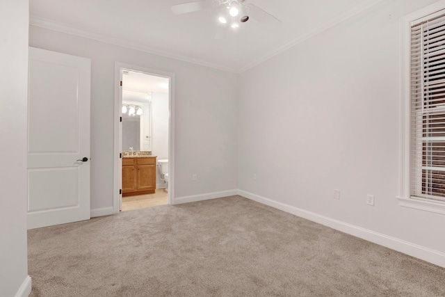 unfurnished room with ornamental molding, light colored carpet, ceiling fan, and baseboards