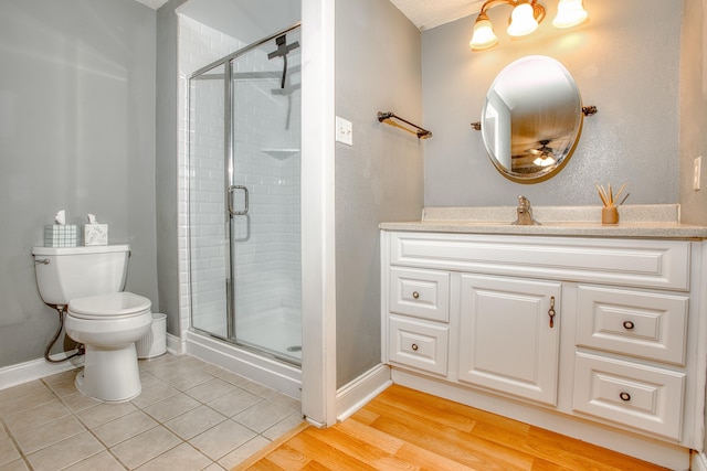 full bathroom with a stall shower, toilet, and baseboards