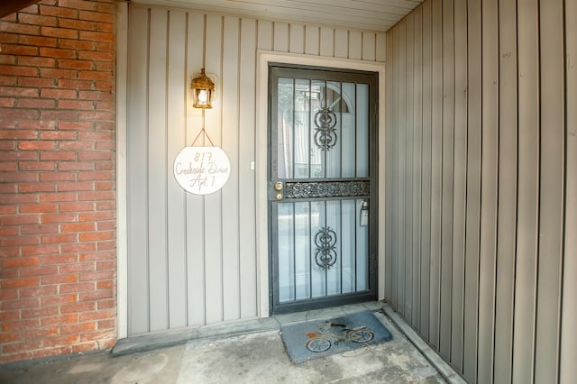 property entrance with brick siding