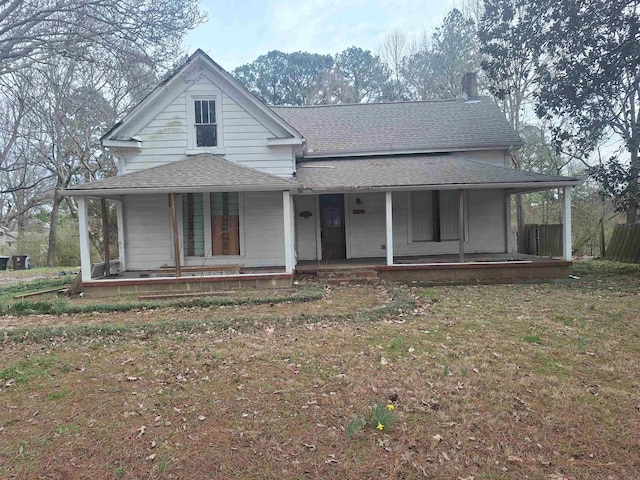 farmhouse inspired home with a porch and a shingled roof