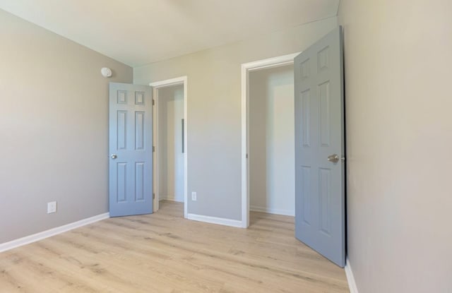 750 Chelsea Dr, Memphis, TN 38107 - unfurnished bedroom with light wood-style flooring and baseboards