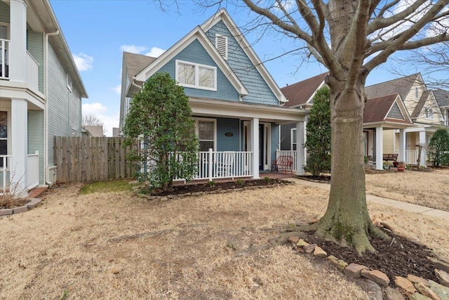 view of front of property featuring a porch and fence