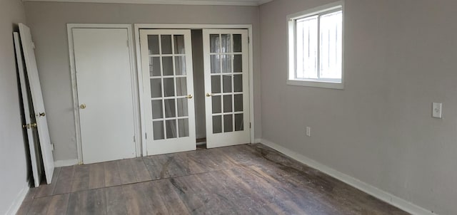 interior space with french doors, baseboards, and wood finished floors