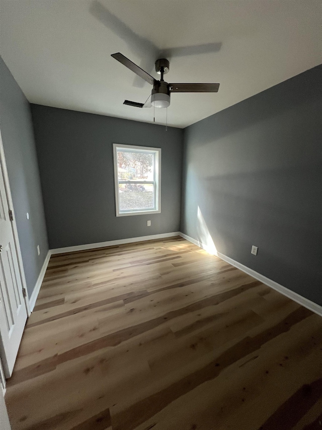 unfurnished bedroom featuring a ceiling fan, baseboards, and wood finished floors