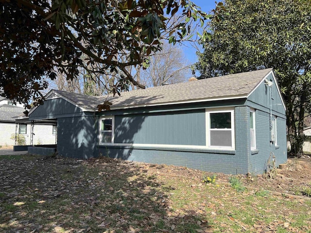 view of property exterior with brick siding