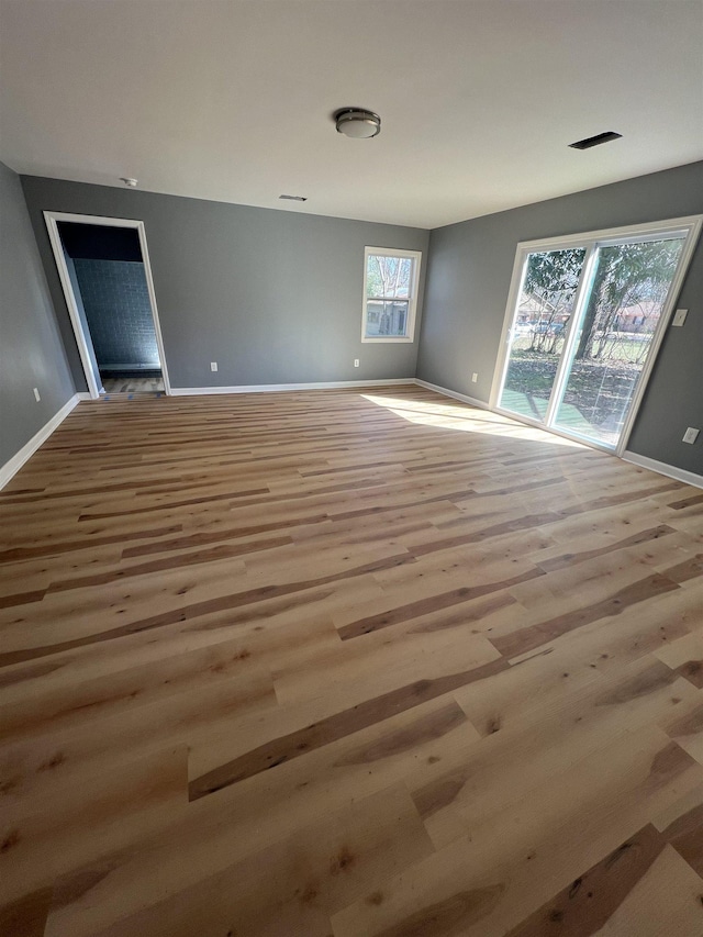 empty room with wood finished floors and baseboards