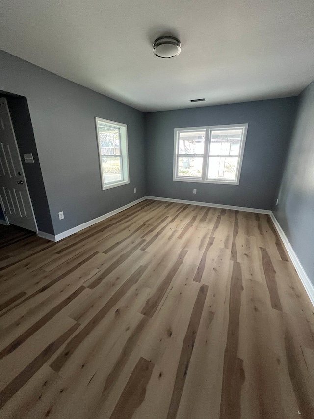 unfurnished room featuring wood finished floors and baseboards