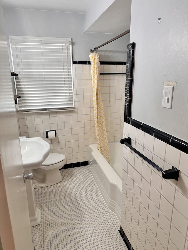 4986 Verosa Ave, Memphis, TN 38117 - bathroom with shower / tub combo, tile walls, toilet, tile patterned floors, and a sink