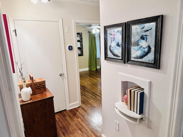 corridor with baseboards and dark wood-style flooring