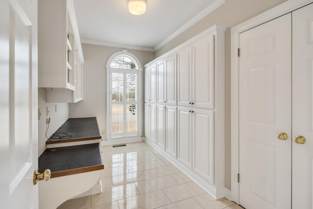 interior space featuring visible vents, baseboards, and crown molding