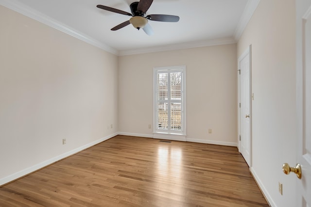 unfurnished room with crown molding, light wood-style flooring, baseboards, and ceiling fan