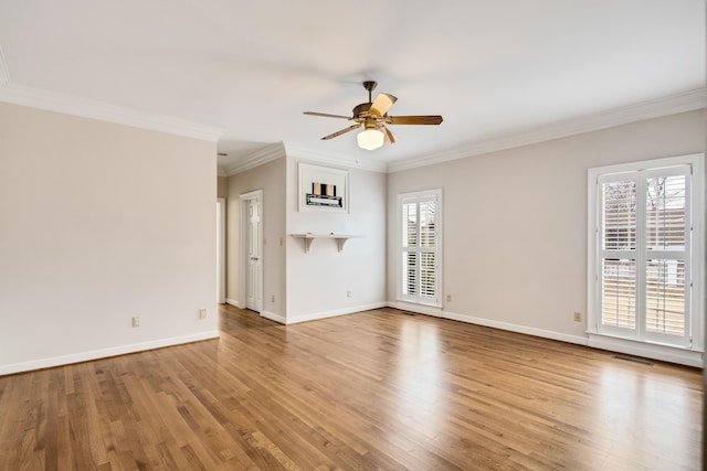 empty room with baseboards, wood finished floors, a ceiling fan, and ornamental molding