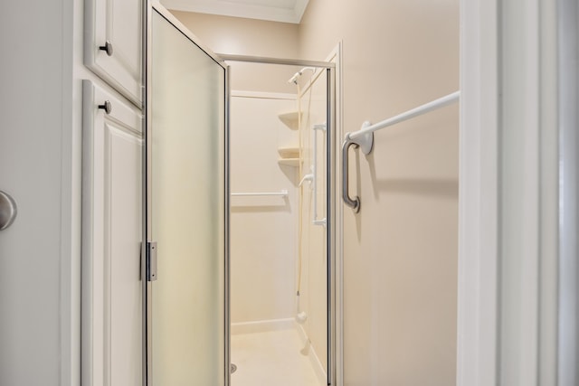 bathroom featuring a shower stall and ornamental molding