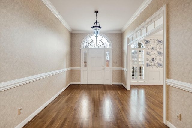 entryway with a wainscoted wall, wood finished floors, crown molding, and wallpapered walls