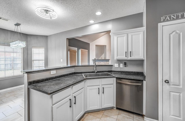 kitchen featuring visible vents, a sink, white cabinetry, a peninsula, and dishwasher