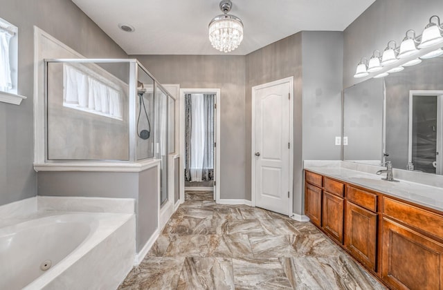 bathroom featuring a jetted tub, a chandelier, a stall shower, marble finish floor, and vanity