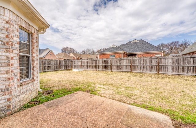 view of yard with a patio and a fenced backyard