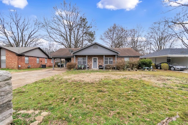 view of front facade with an attached carport, concrete driveway, brick siding, and a front yard