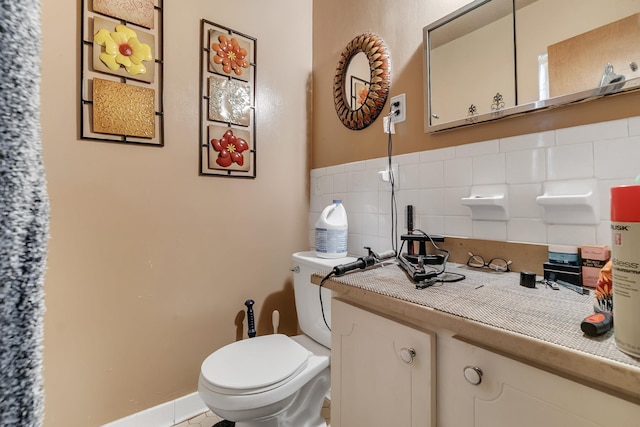 bathroom with decorative backsplash, toilet, and vanity