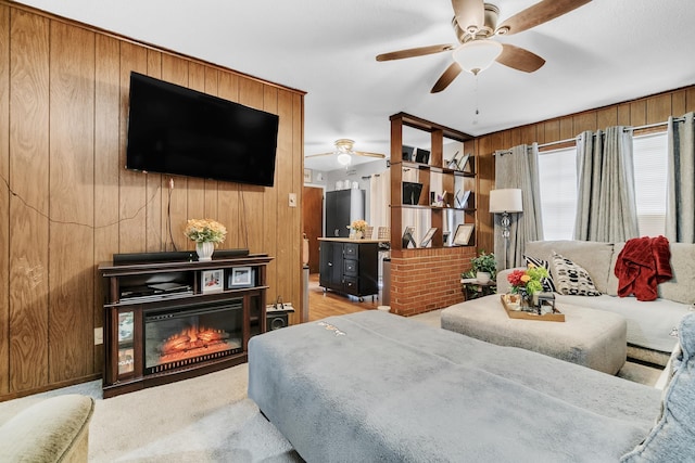 bedroom with a glass covered fireplace, light colored carpet, and wood walls