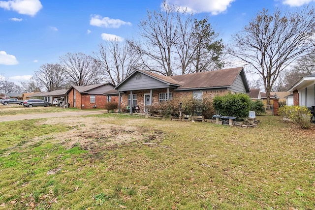 view of front of property with brick siding and a front yard