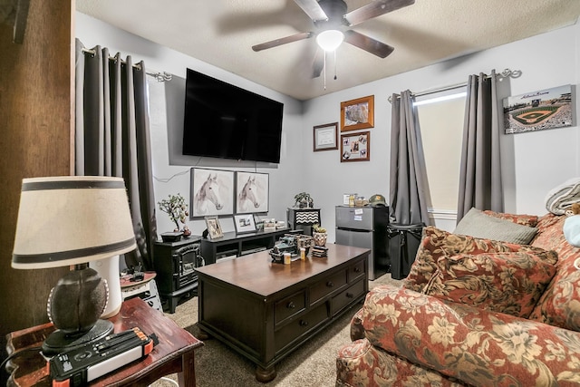 office with light colored carpet, a textured ceiling, and a ceiling fan