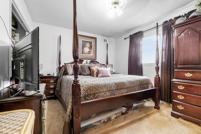 bedroom with visible vents and light carpet