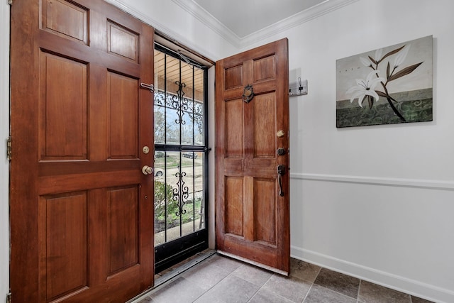 entrance foyer with crown molding and baseboards