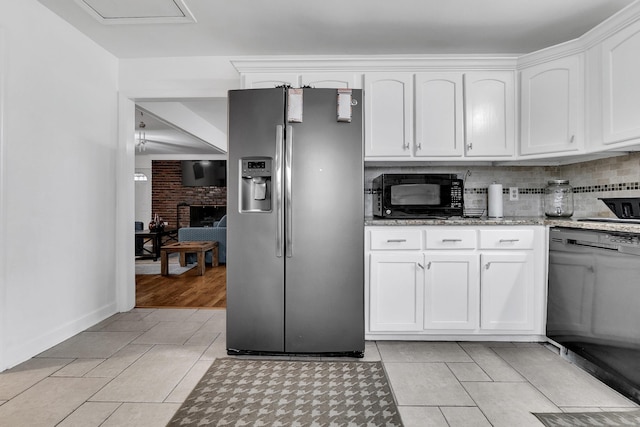 kitchen with white cabinetry, black appliances, light tile patterned flooring, and decorative backsplash