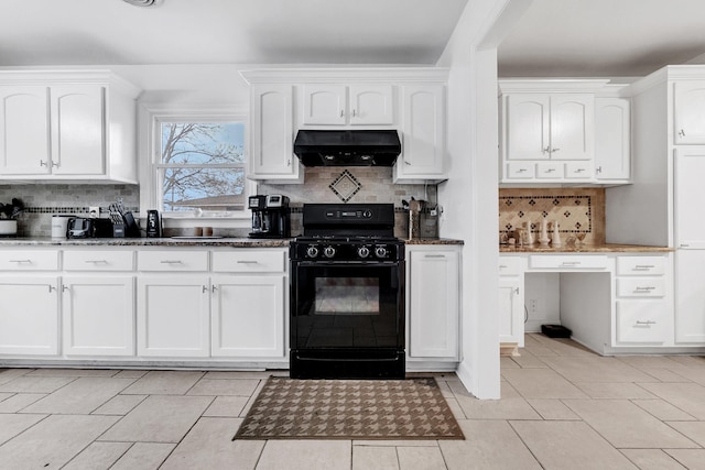 kitchen featuring ventilation hood, dark stone counters, white cabinetry, and gas stove