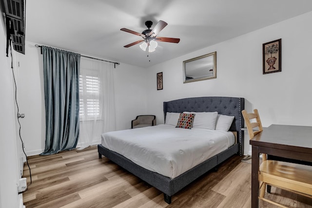 bedroom featuring a ceiling fan and light wood finished floors