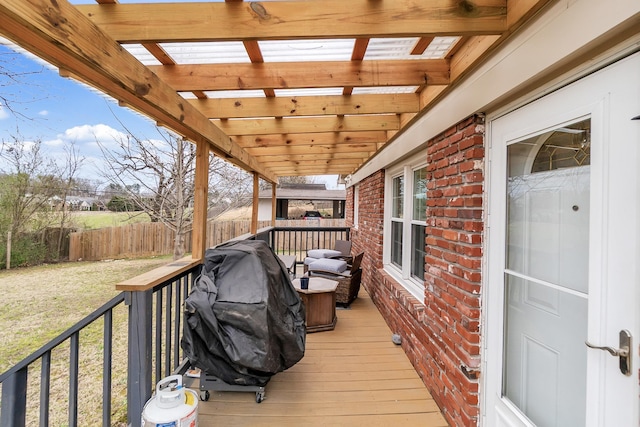 wooden deck featuring a pergola, a yard, and fence