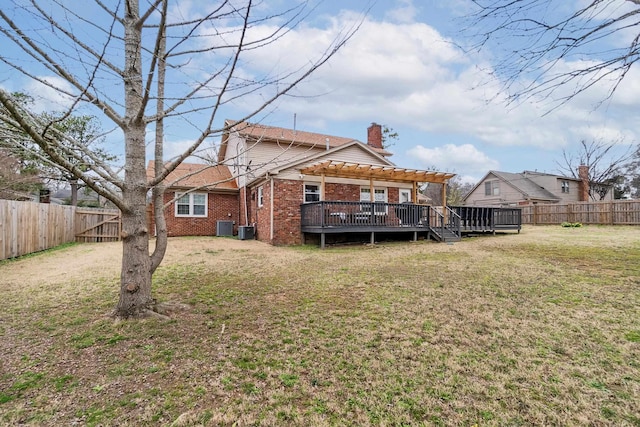 back of house with a yard, a fenced backyard, a pergola, a chimney, and brick siding