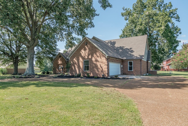 view of front facade with driveway, a shingled roof, a front lawn, a garage, and brick siding