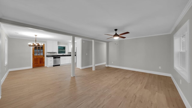 unfurnished living room with crown molding, ceiling fan with notable chandelier, baseboards, and light wood finished floors