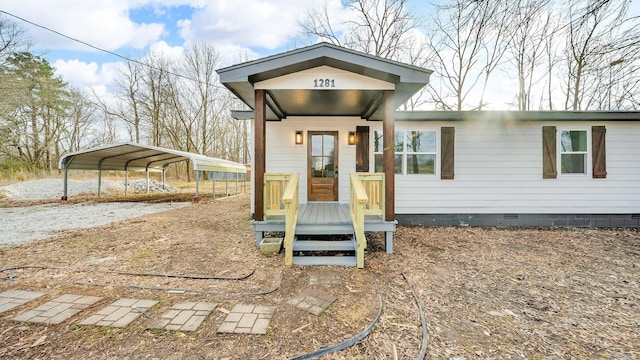 view of front facade with crawl space and a detached carport