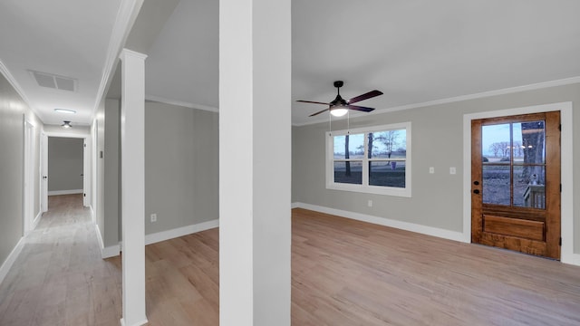 interior space with baseboards, light wood-style floors, visible vents, and ornamental molding