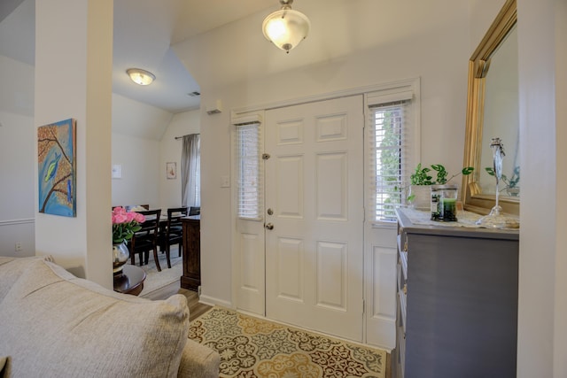 entrance foyer featuring vaulted ceiling